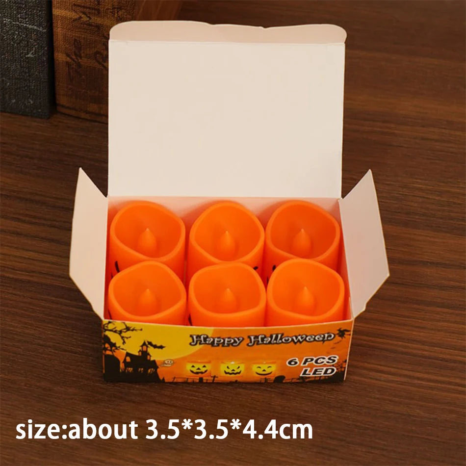 Six Pack Tealights: six small pumpkin tealights in an open box, about 3.5 x 3.5 x 4.4 cm each