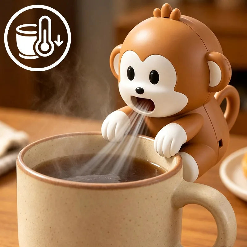 Brown cartoon monkey fan hooked over the rim of a mug, blowing air down across a hot drink
