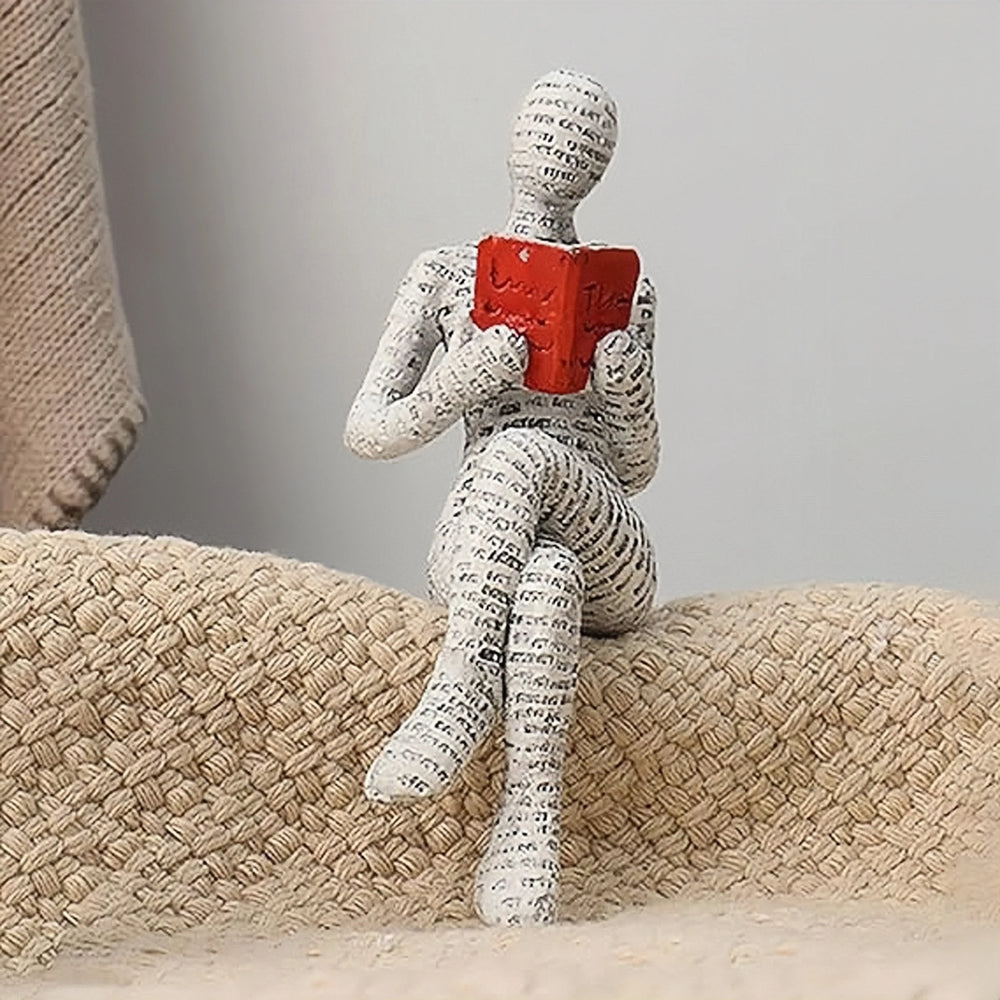 The shelf-sitting figure perched on the arm of a woven chair
