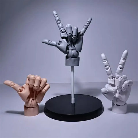 Three poseable hand models side by side in skin tone, grey and white, each mounted on a round black stand
