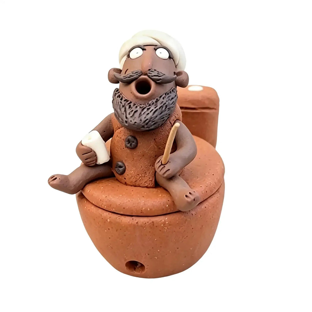 Terracotta resin figure sitting on a toilet holding a stick and a roll, plain background