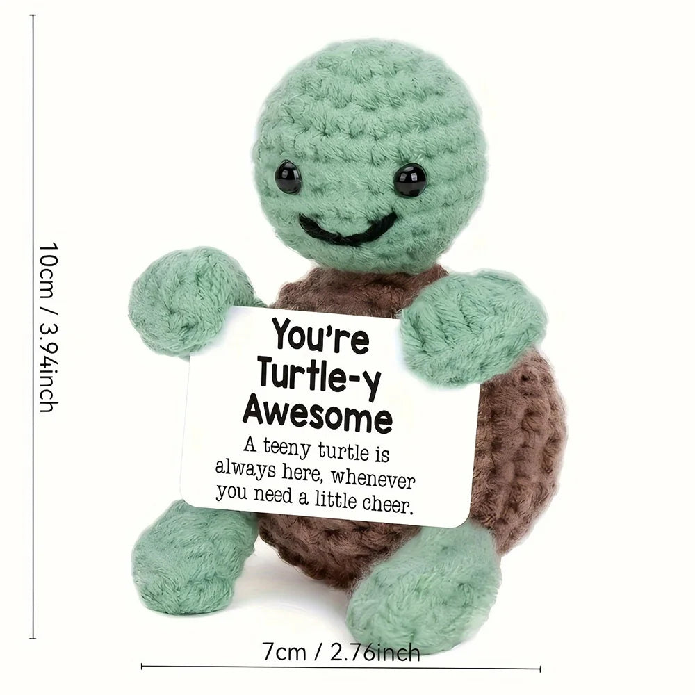 Crochet positive affirmation doll holding an encouragement card