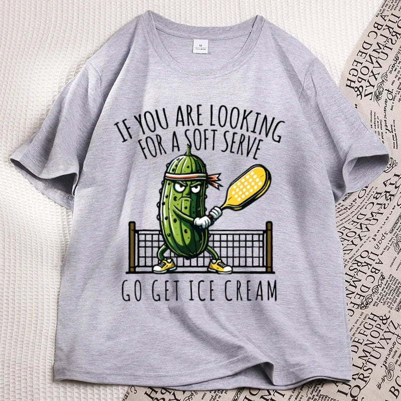Grey pickleball tee laid flat, cartoon pickle with a paddle printed on the chest