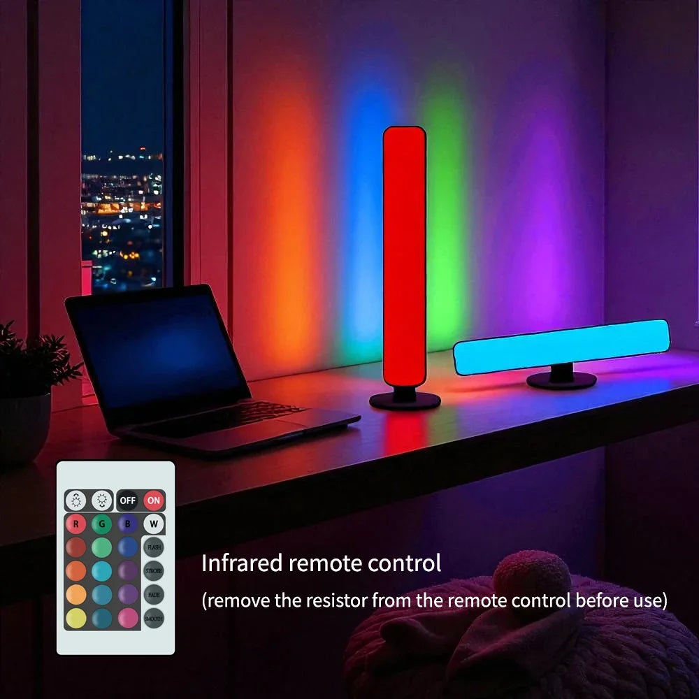A red upright bar and a cyan flat bar on a desk at night, shown with the infrared handset