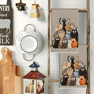 The two cat towels draped over the rungs of a wooden ladder rack against a white wall