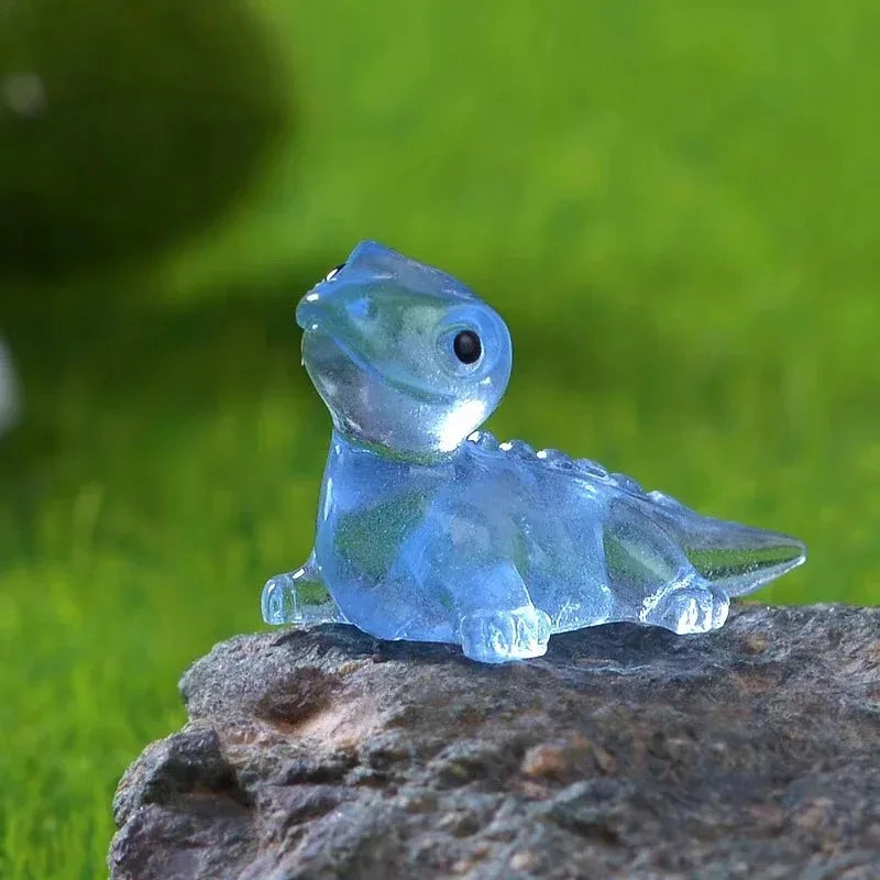 A translucent pale blue lizard perched on a rock