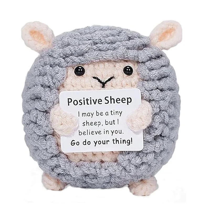Crochet positive affirmation doll holding an encouragement card