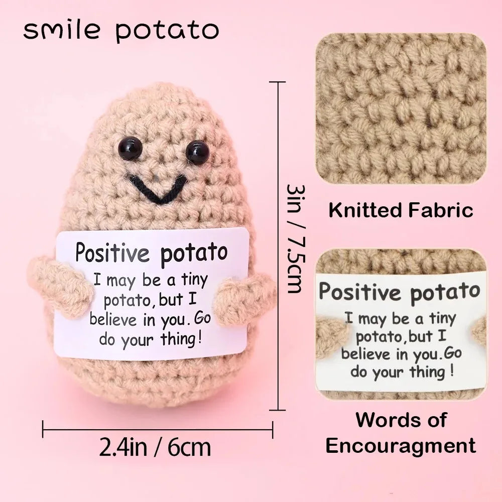Crochet positive affirmation doll holding an encouragement card