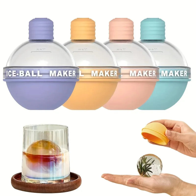 Four ice ball molds in a row above a glass holding a single round ice ball and a hand holding a ball with a herb sprig frozen inside