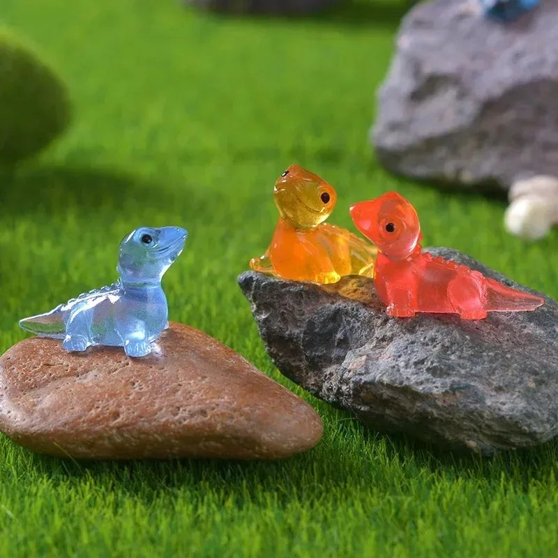 Blue, orange and red lizards arranged on a rock and grass