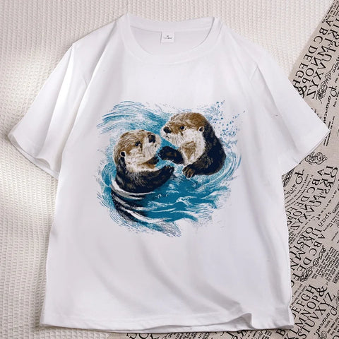 White sea otter tee laid flat, two otters printed on the chest