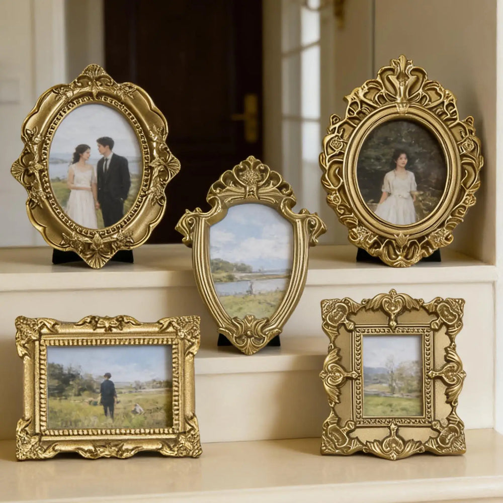 The five ornate gold frames arranged on a mantel with tiny portrait and landscape prints