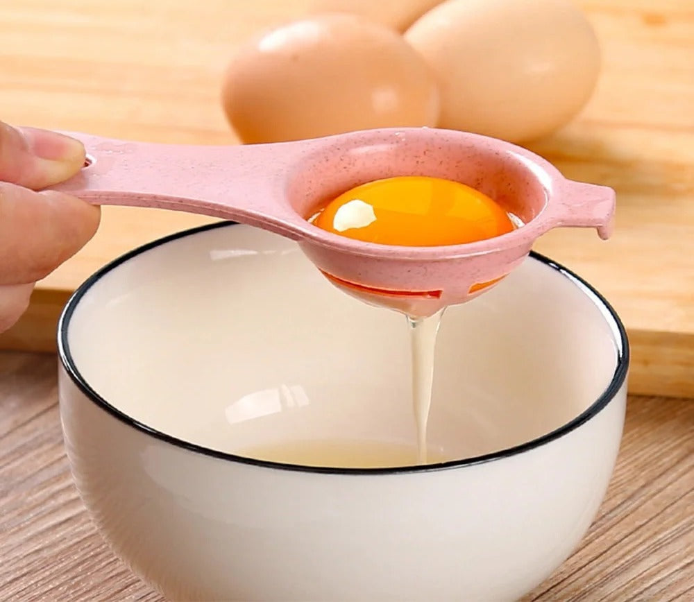 The white draining through the pink separator into a bowl while the yolk stays in the cup