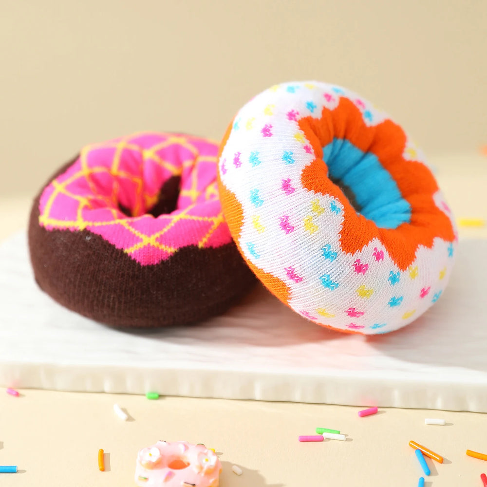 Both rolled donut socks side by side on a pale surface