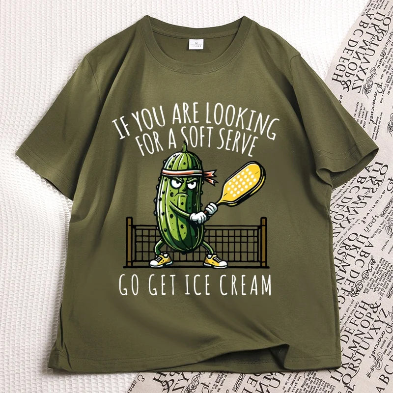 Army green pickleball tee laid flat, cartoon pickle with a paddle printed on the chest
