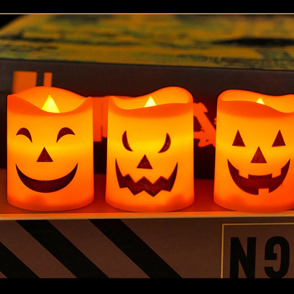 Three lit pumpkin tealight candles with carved faces on a shelf