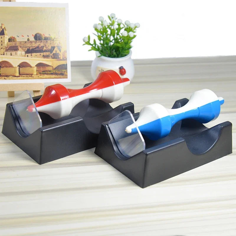 Two of the tops on a shelf beside a small plant