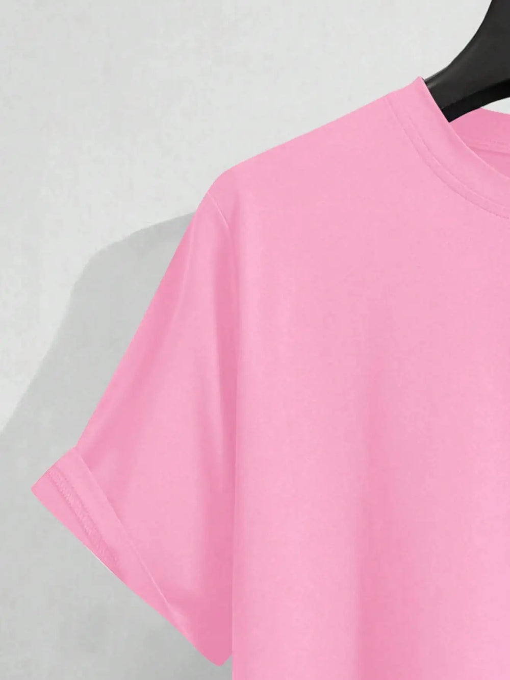 Close view of the pink tee sleeve and shoulder seam