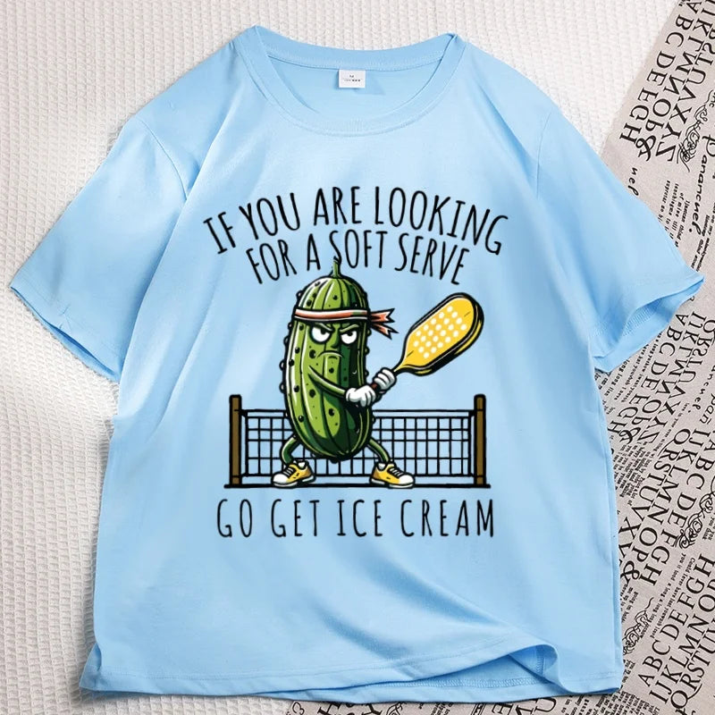 Sky blue pickleball tee laid flat, cartoon pickle with a paddle printed on the chest