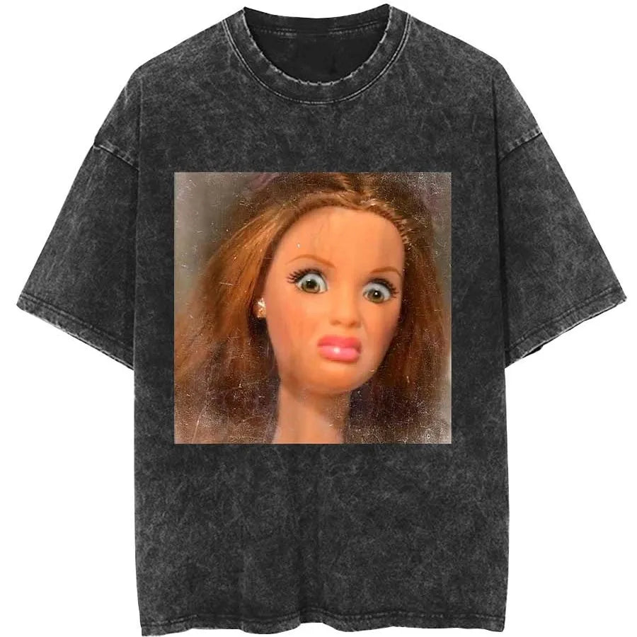 Washed charcoal tee printed with a close-up photograph of a red-haired fashion doll pulling a pained grimace