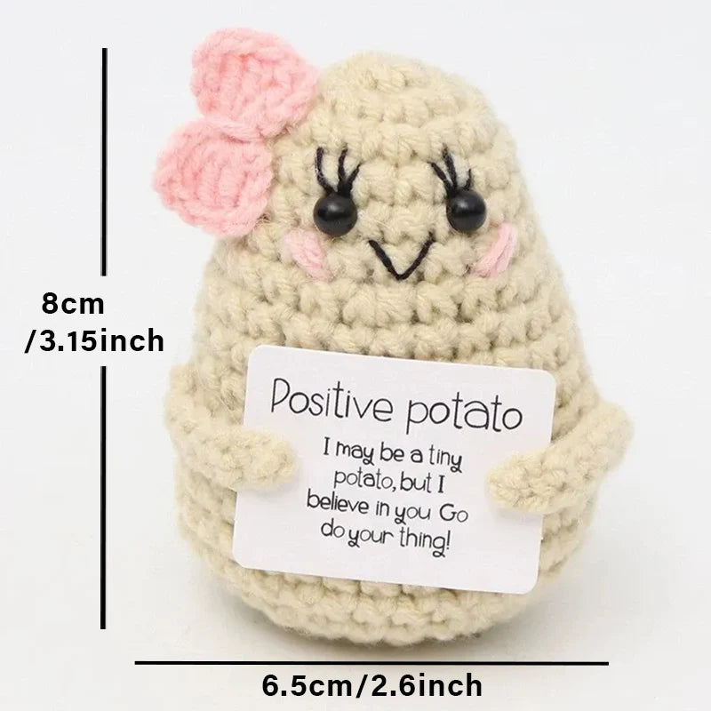 Crochet positive affirmation doll holding an encouragement card