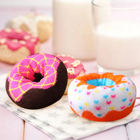 Two socks rolled into donuts, one pink iced and one white with sprinkles