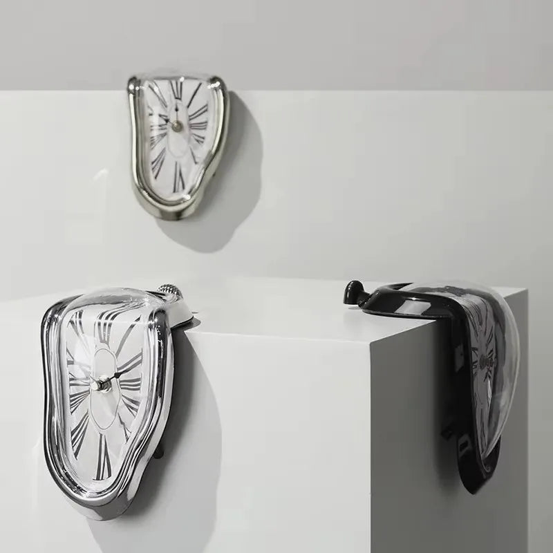 Three melting clocks arranged over the corner of a white block