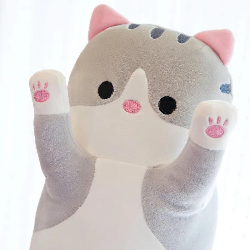 Close-up of the plush cat face, pink inner ears and paw pads