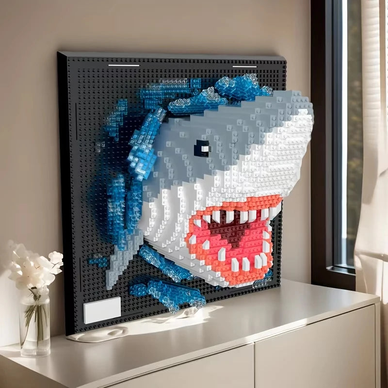 Brick built shark bursting out of a black studded panel with open jaws and blue water bricks, standing on a sideboard beside a vase