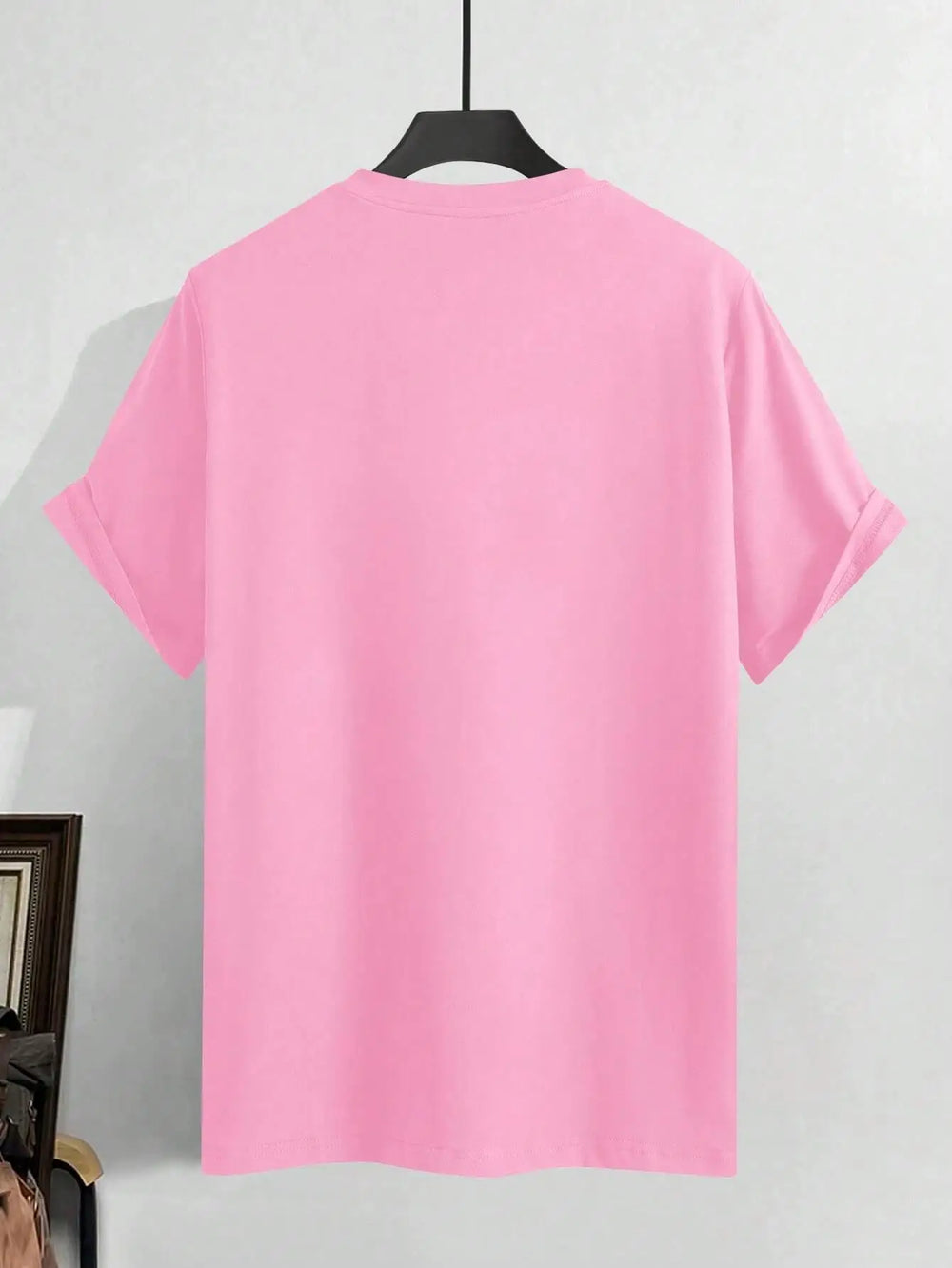 Pink cotton tee shown from the side, the printed front turned away