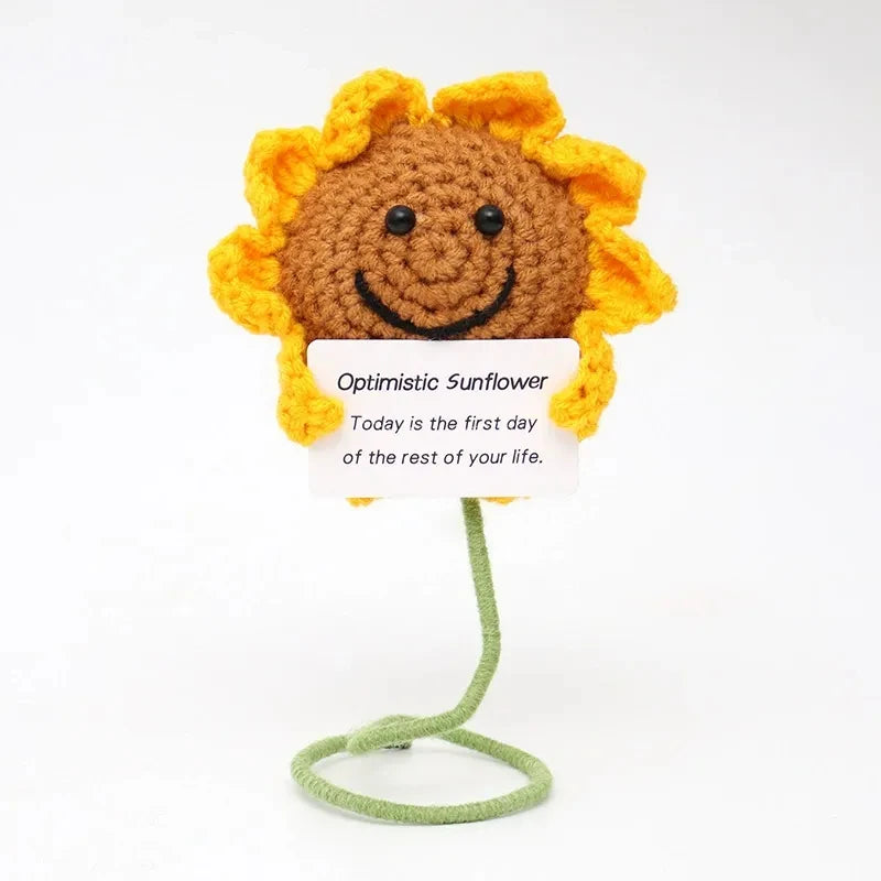 Crochet positive affirmation doll holding an encouragement card