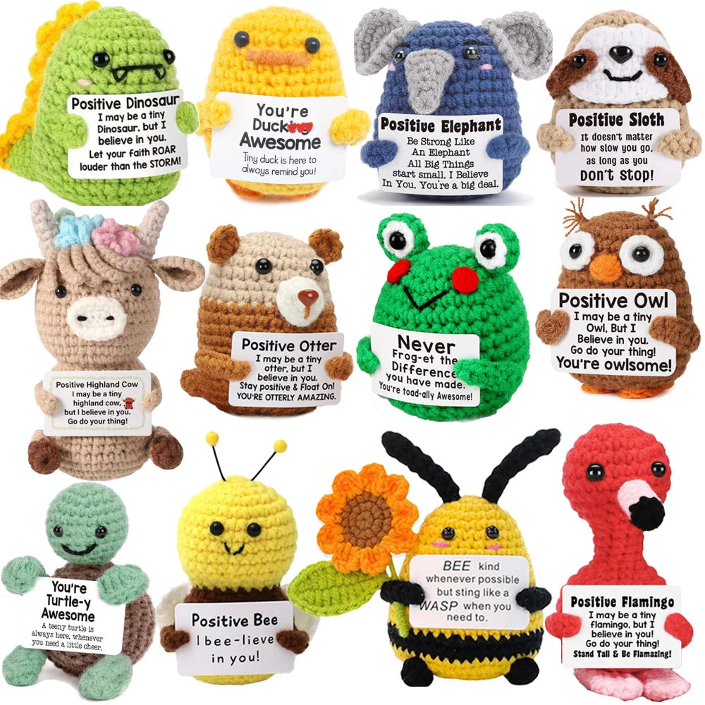 Crochet positive affirmation doll holding an encouragement card