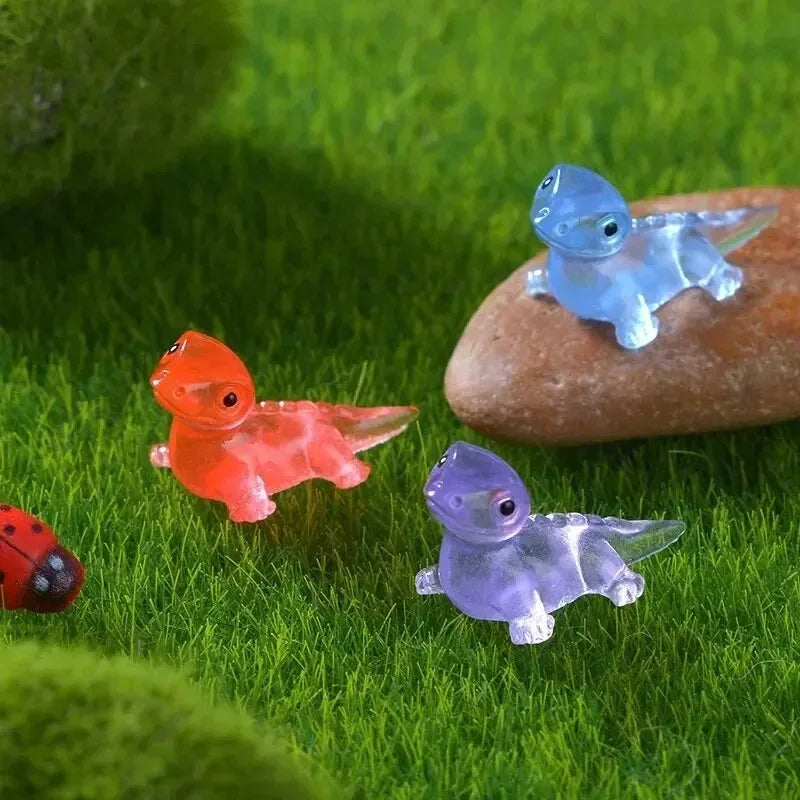 Red, blue and purple lizards on moss beside a ladybird