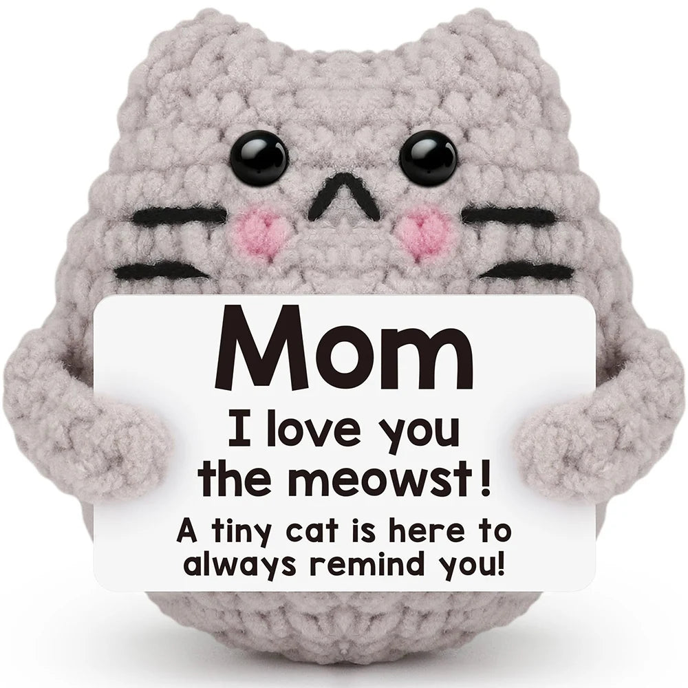 Crochet positive affirmation doll holding an encouragement card