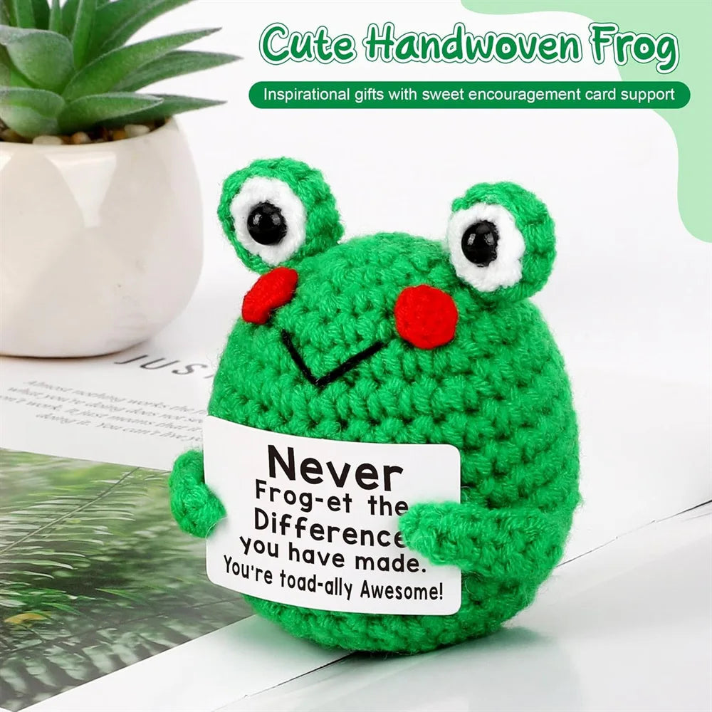 Crochet positive affirmation doll holding an encouragement card
