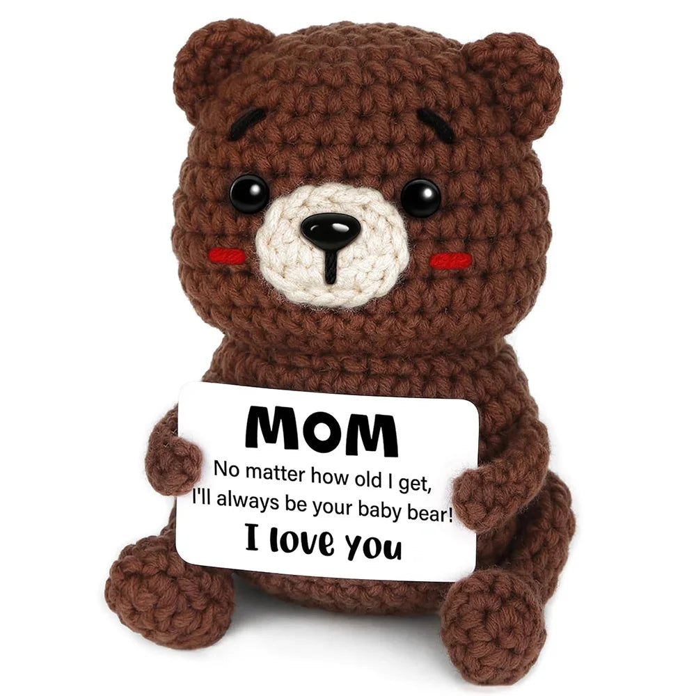 Crochet positive affirmation doll holding an encouragement card