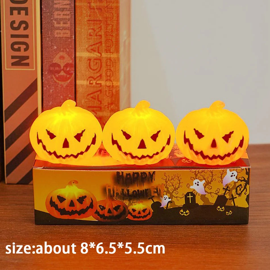 Three Pack: three lit pumpkin lanterns on their box, about 8 x 6.5 x 5.5 cm each