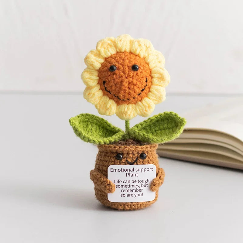 Crochet positive affirmation doll holding an encouragement card