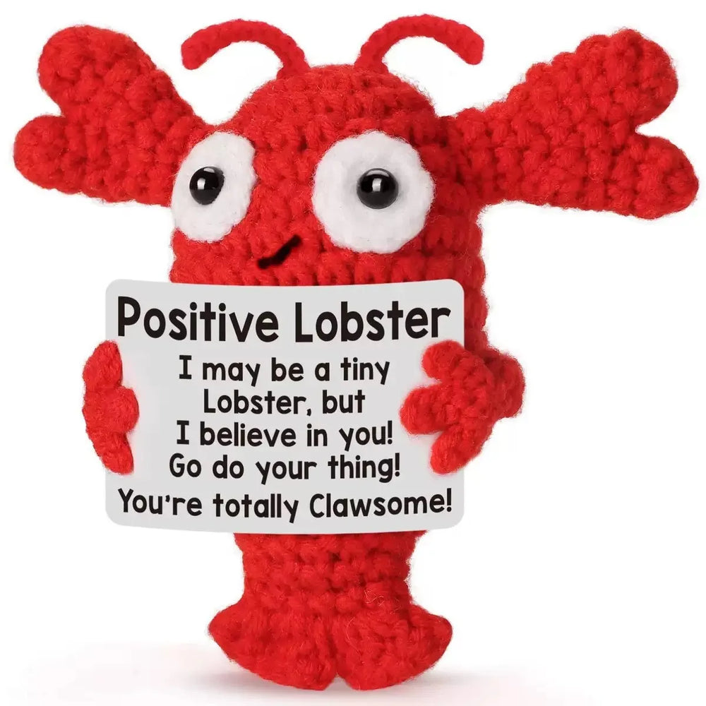 Crochet positive affirmation doll holding an encouragement card
