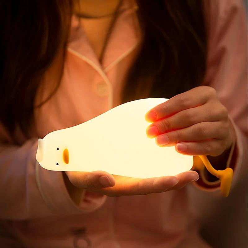Duck lamp lit warm and held in two hands
