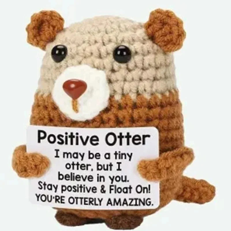 Crochet positive affirmation doll holding an encouragement card