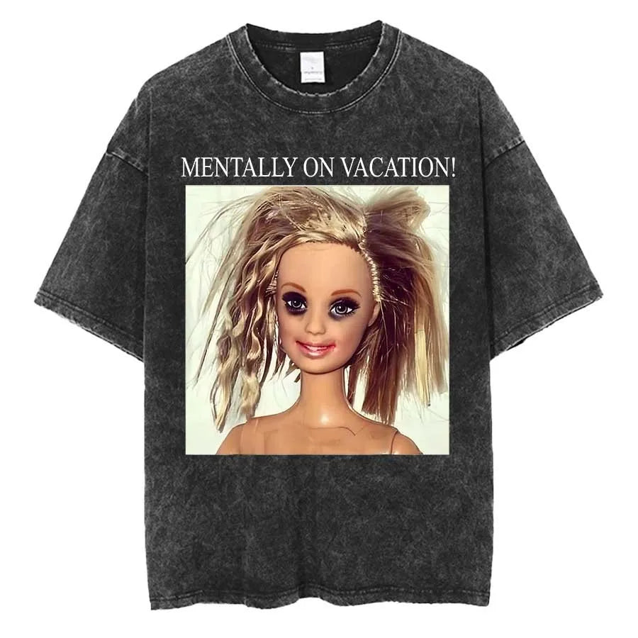 Washed charcoal tee printed with a photograph of a blonde fashion doll with wild hair under the words MENTALLY ON VACATION