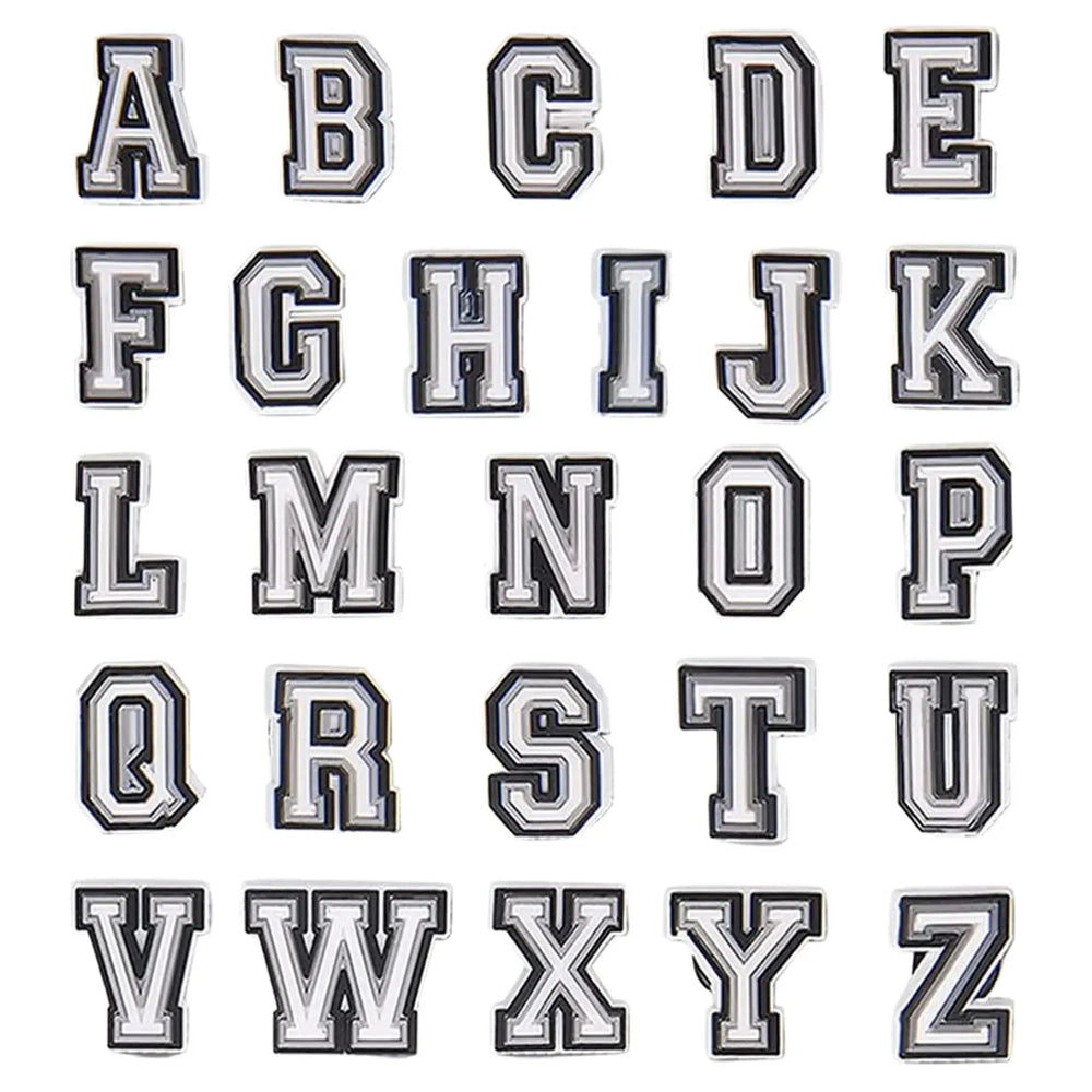All 26 charms laid out in a grid, A through Z