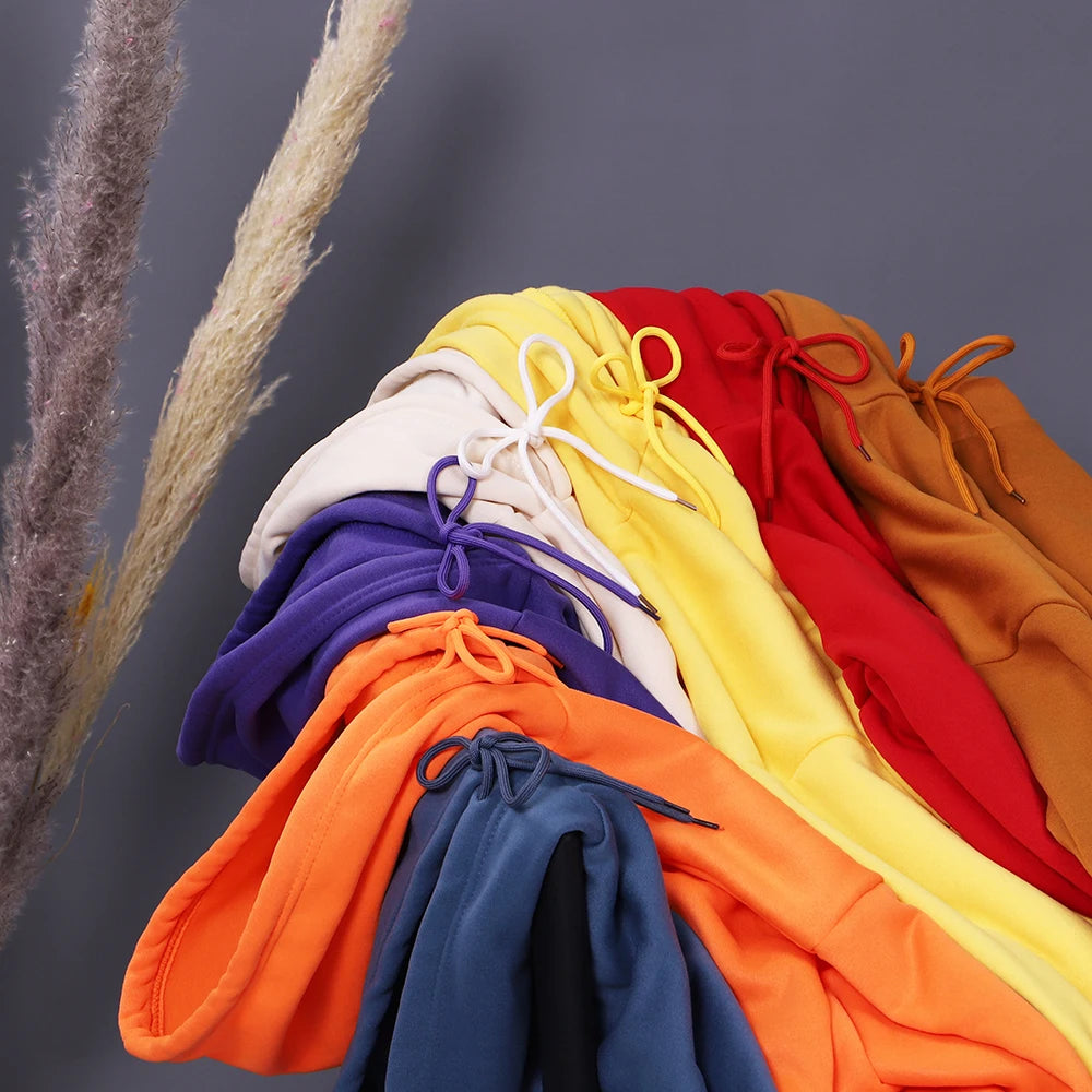 Fourteen colourways of the starry night cat hoodie stacked together, hoods and drawstrings showing