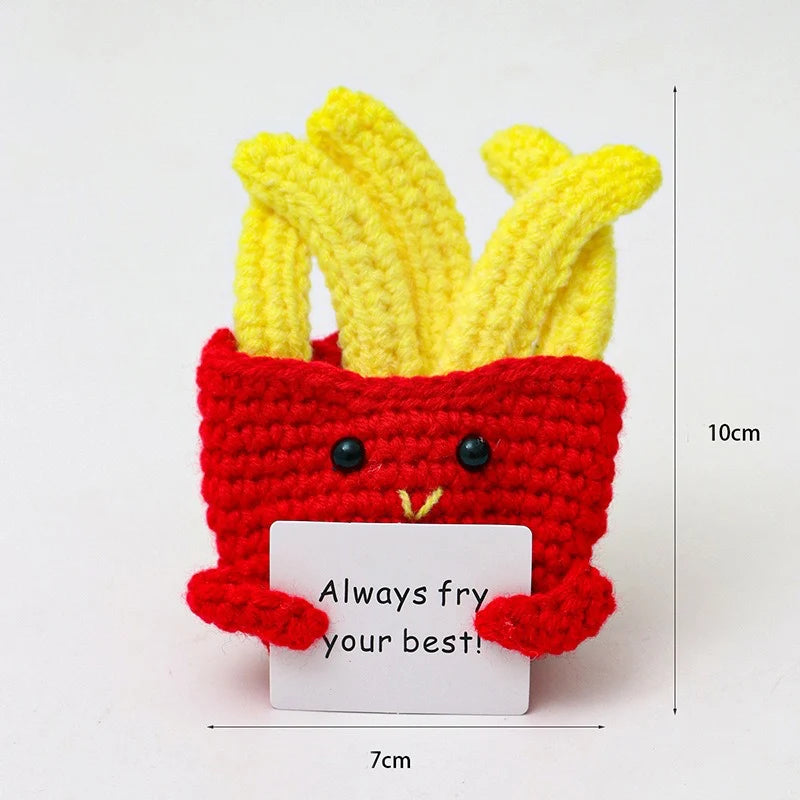 Crochet positive affirmation doll holding an encouragement card