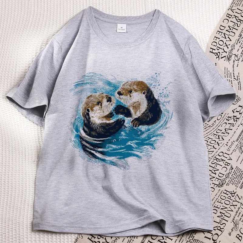 Grey sea otter tee laid flat, two otters printed on the chest