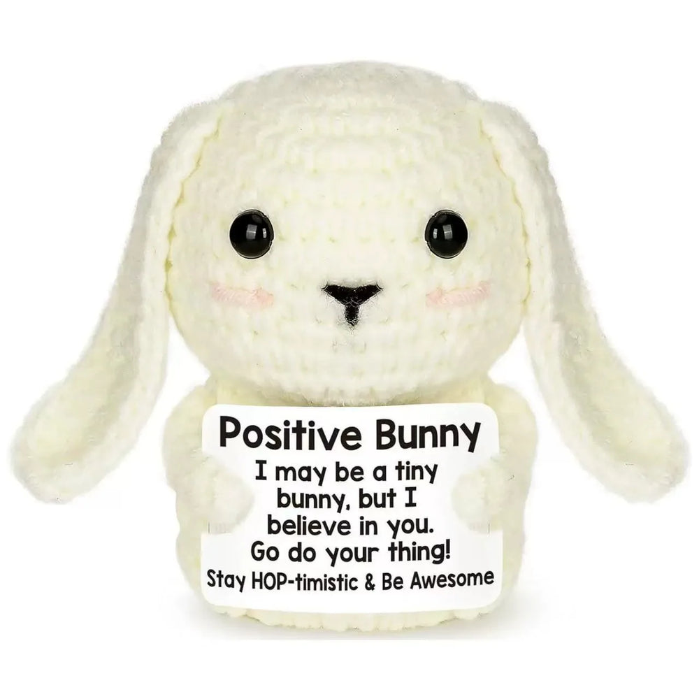 Crochet positive affirmation doll holding an encouragement card