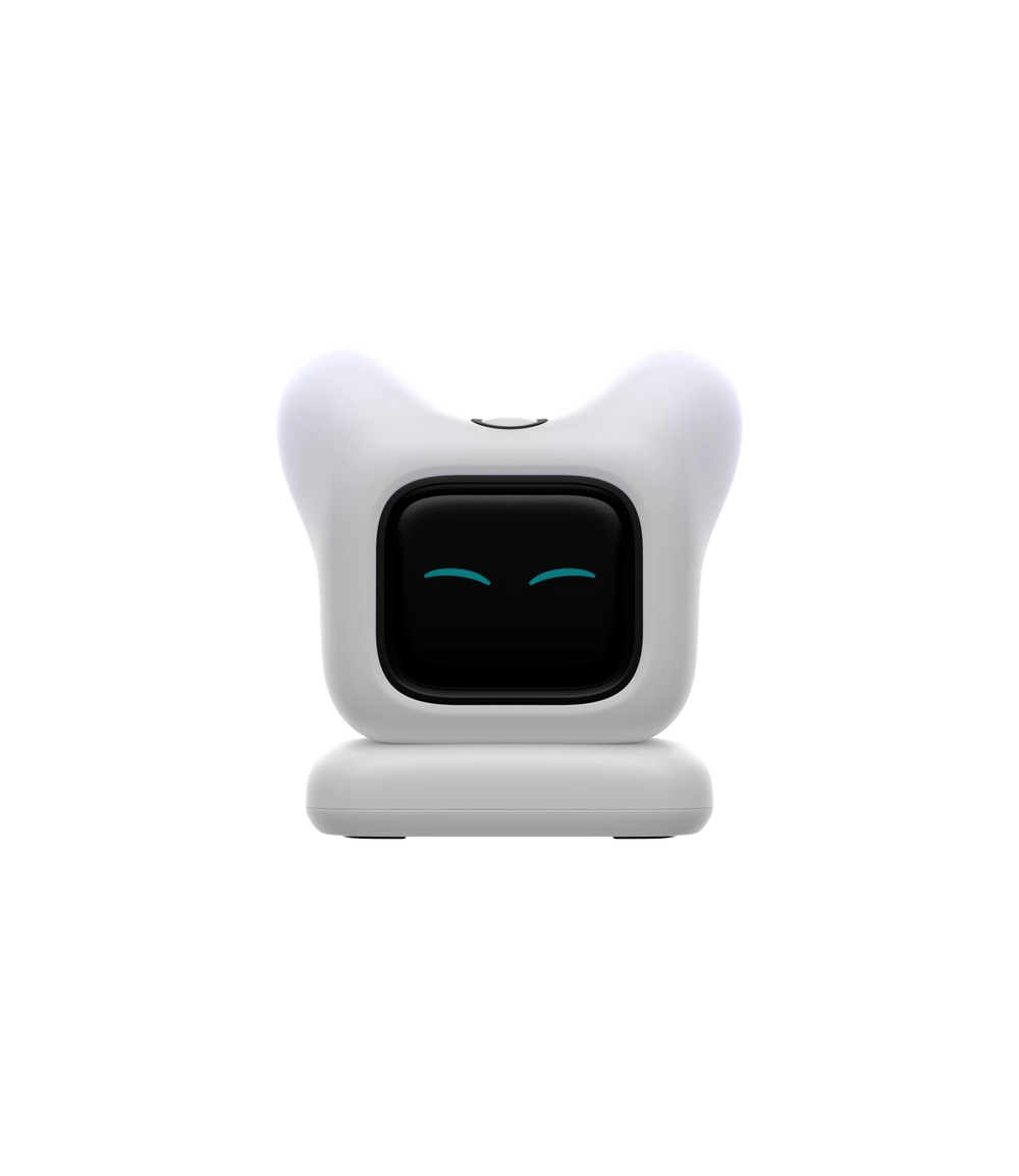 White desk robot with two soft ears and a black screen face showing closed teal eyes, on its moulded base