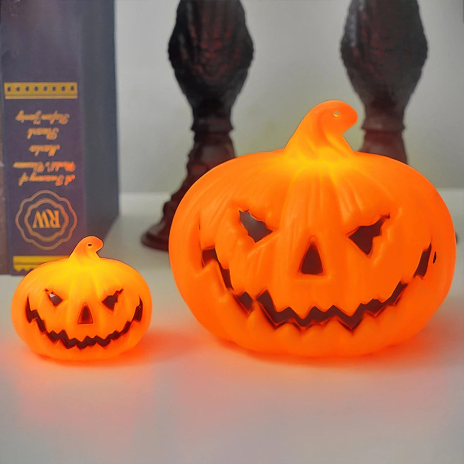 A small and a large lit pumpkin lantern side by side
