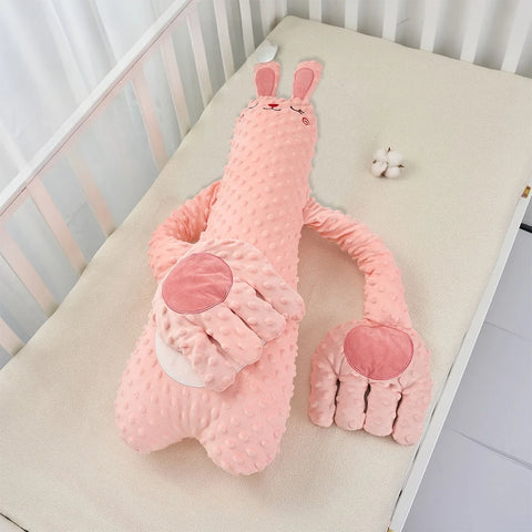 The pink rabbit design lying on a cot mattress, showing the long body and the two folded arms